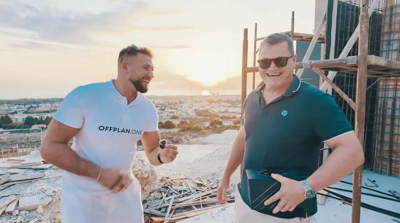 Offplan.one team member with an investor at a Cyprus construction site at sunset