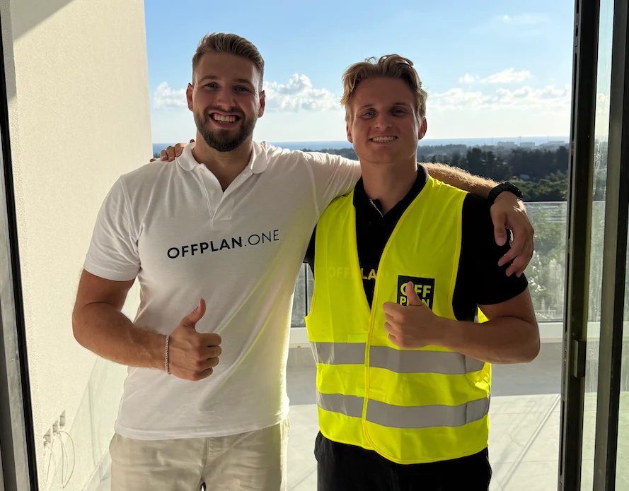 Two Offplan.one team members on a balcony at a Cyprus development